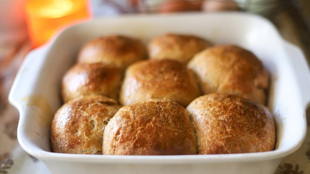 Close-up of baked sourdough rolls in a white pan