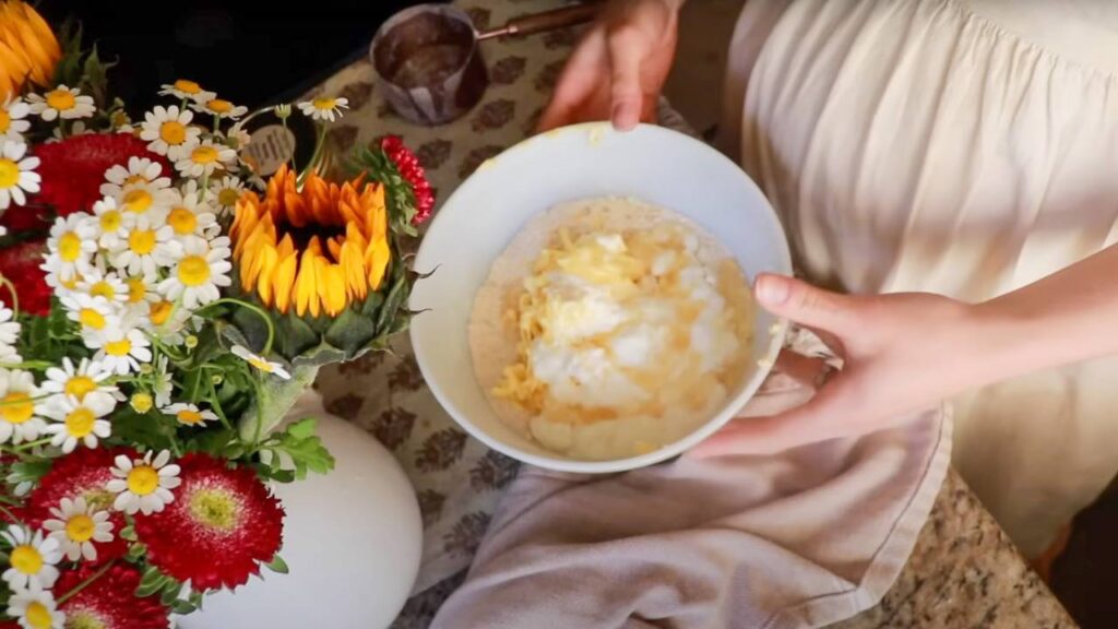Mixing bowl with flour, grated butter, and other ingredients.
