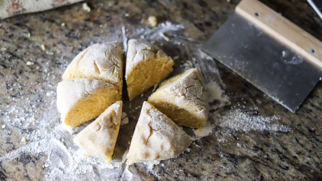 Wedges of dough cut and floured on a countertop.