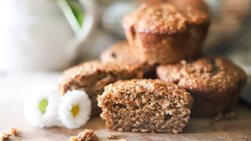 Close-up of a sliced muffin on a wooden board.