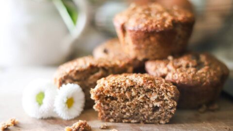 Close-up of a sliced muffin on a wooden board.