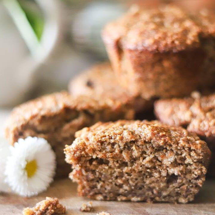Close-up of a sliced muffin on a wooden board.