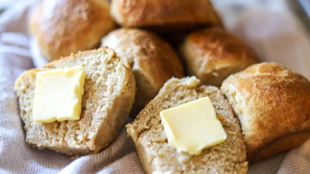 Basket of freshly milled sourdough dinner rolls with butter