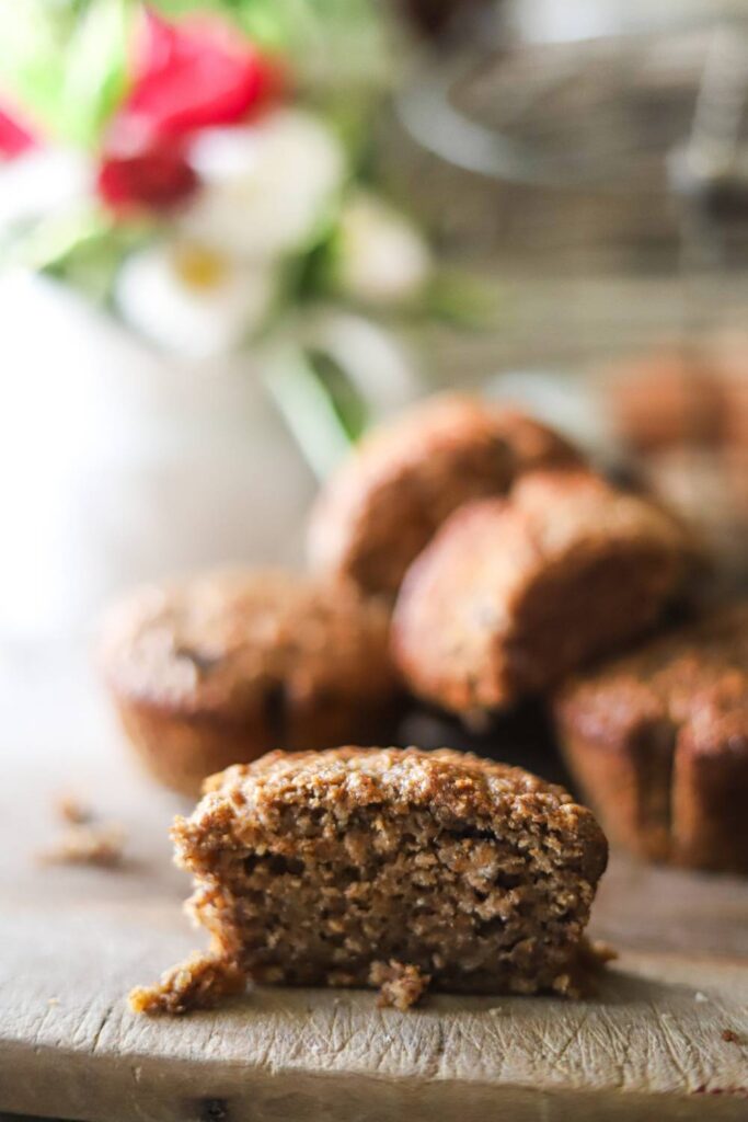 Close-up of a sliced muffin on a wooden board.