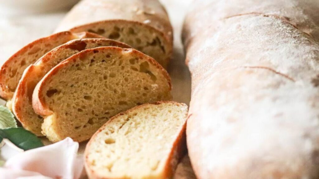 Two loaves of einkorn sourdough French bread on a cutting board