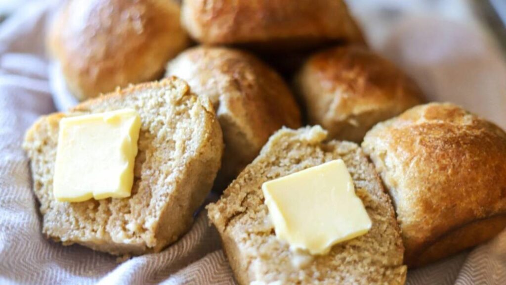 Freshly milled sourdough rolls with butter on top