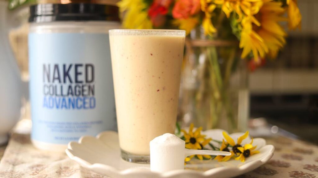Collagen smoothie with Naked Collagen Advanced container and flowers on counter
