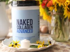 Naked Collagen Advanced container on plate with scoop and fresh flowers