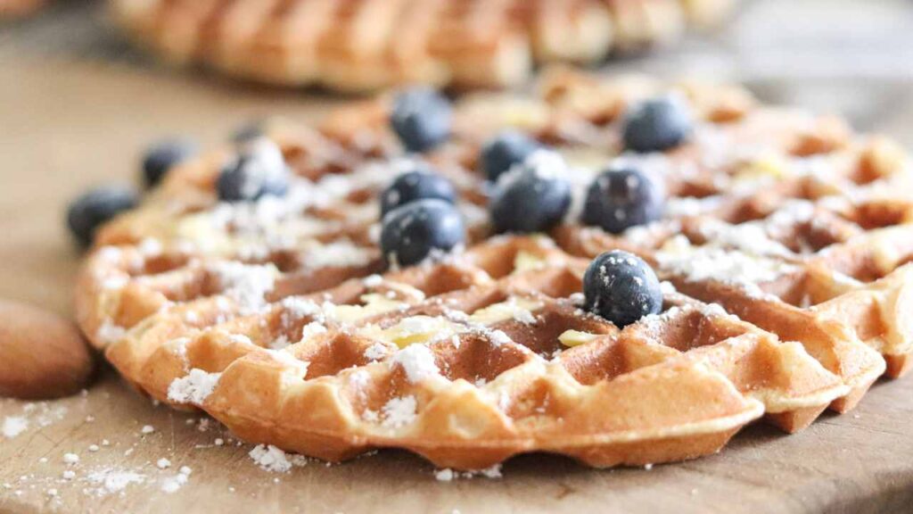 close-up of einkorn flour waffles with blueberries and powdered sugar on top