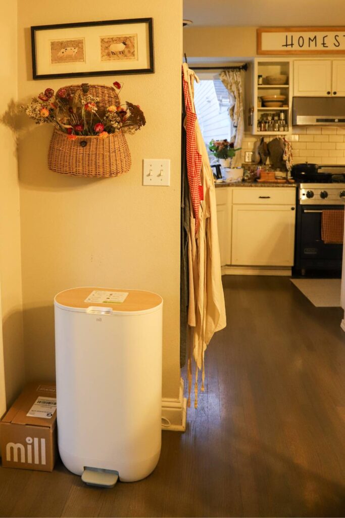 Mill food recycler placed in a hallway next to a kitchen