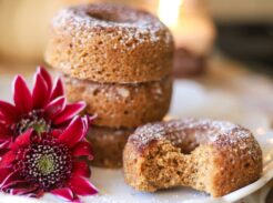 Stack of whole grain apple cider donuts with a bite taken out