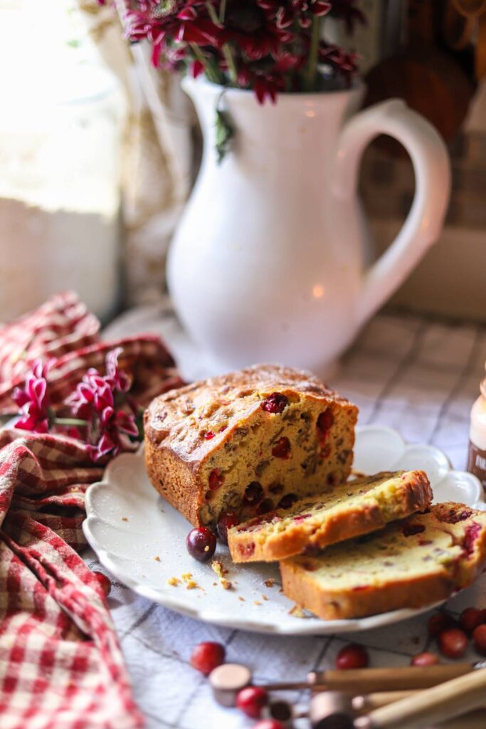 Loaf of einkorn cranberry orange bread with sliced pieces
