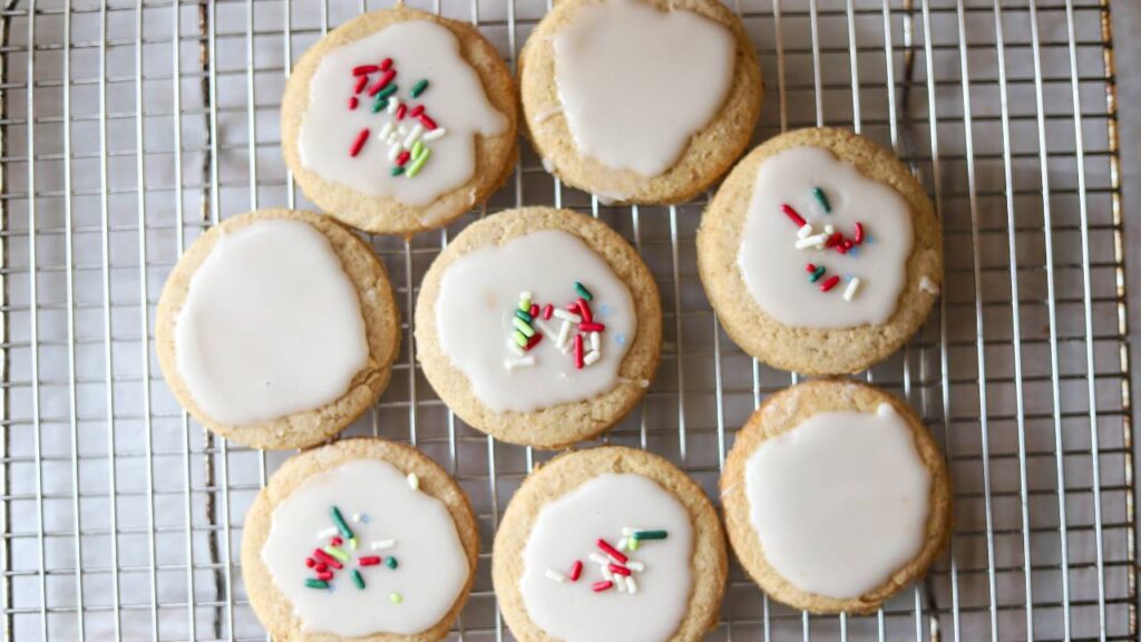 Overhead view of iced whole grain sugar cookies on a cooling rack