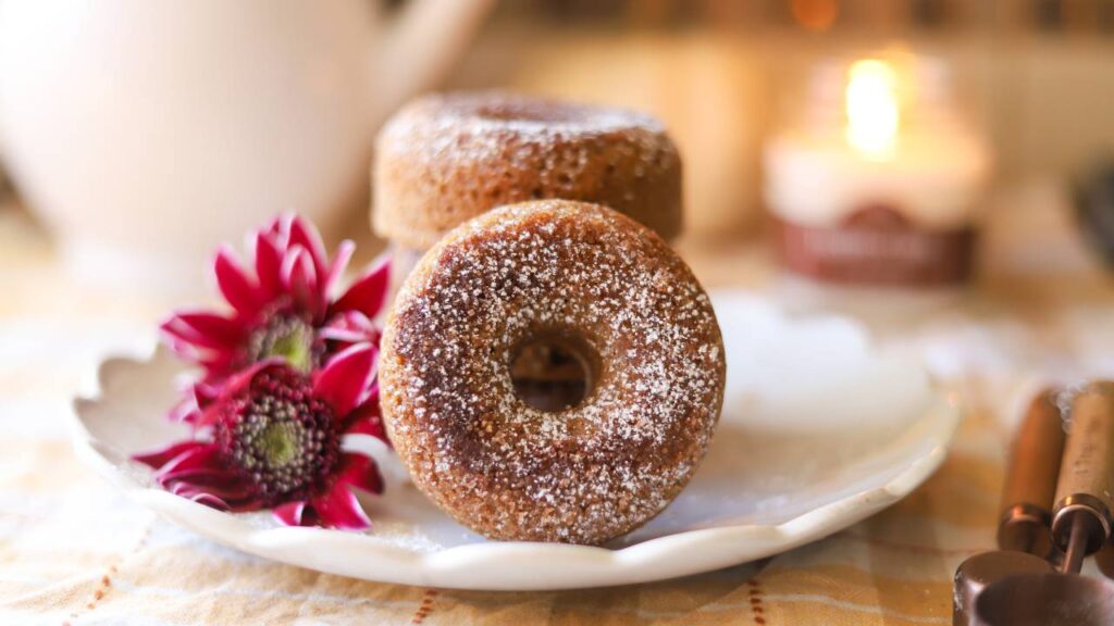 Whole grain apple cider donuts on a plate with fall decor