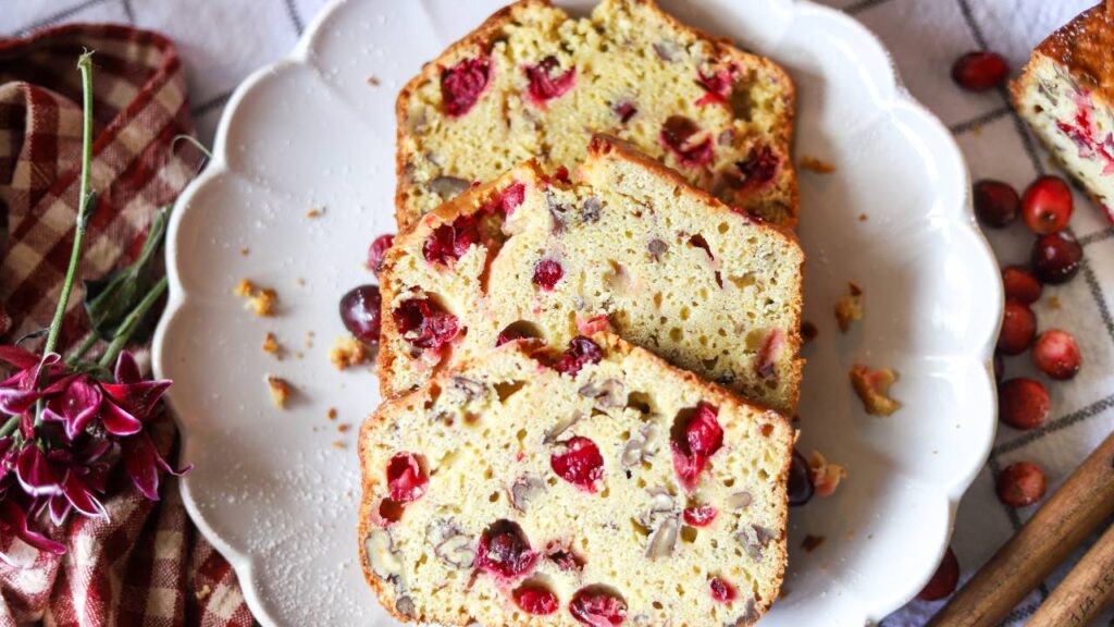 Overhead view of sliced cranberry orange bread on a plate