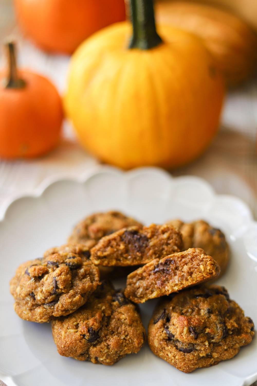 Pumpkin coconut chocolate chip cookies broken open to show the soft center