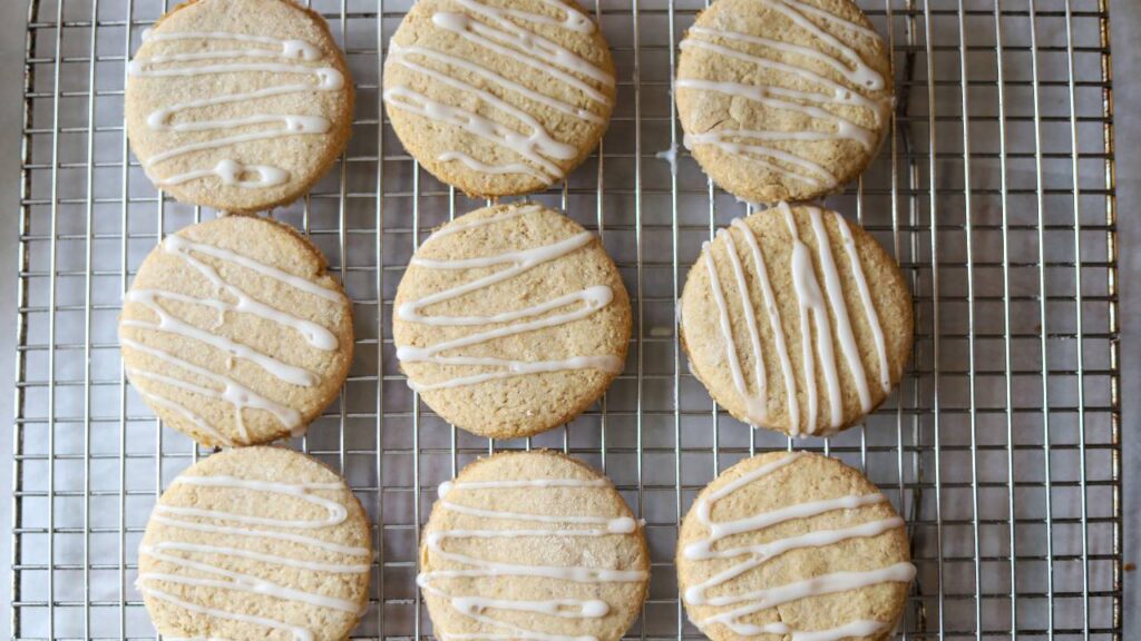 Overhead view of iced whole grain sugar cookies on a cooling rack