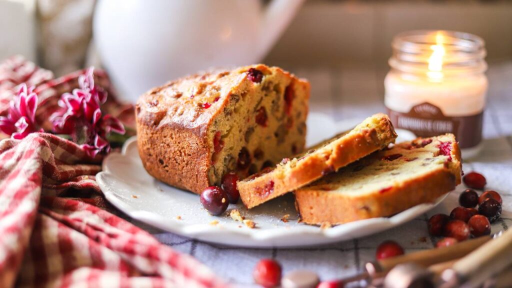 Baked cranberry orange bread loaf with fresh cranberries