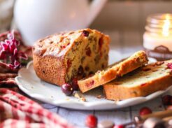 Baked cranberry orange bread loaf with fresh cranberries