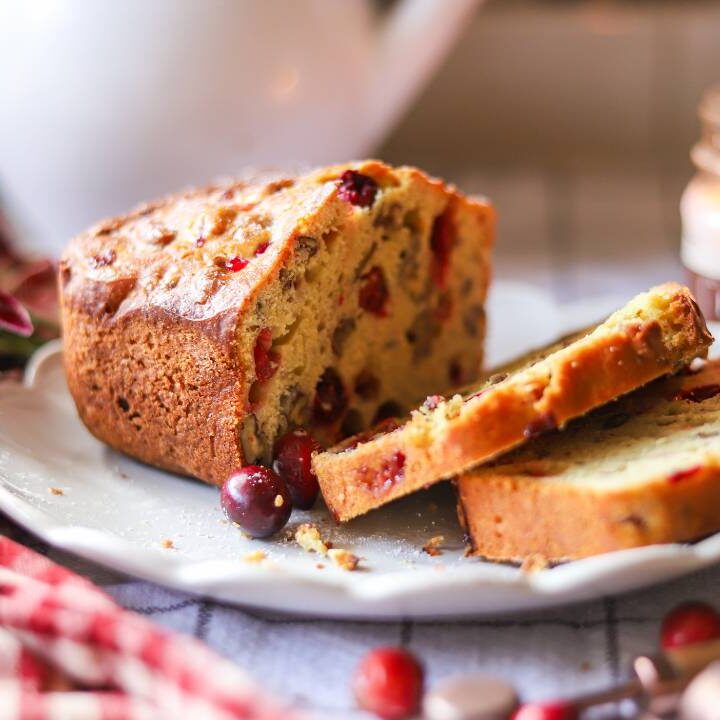 Baked cranberry orange bread loaf with fresh cranberries