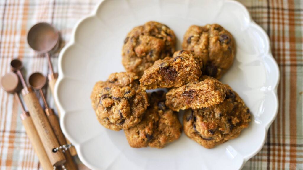 Overhead view of pumpkin coconut chocolate chip cookies on a white plate