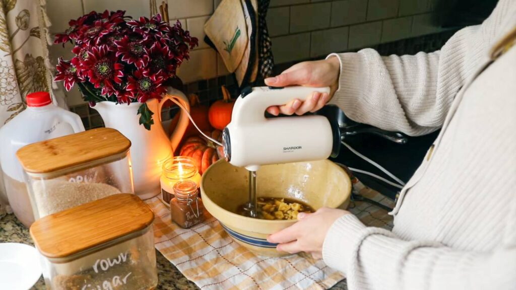 Mixing apple cider donut batter in a bowl