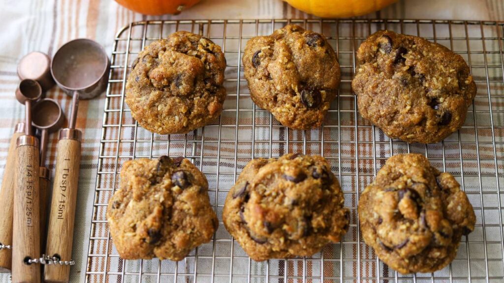 Pumpkin coconut chocolate chip cookies arranged on a cooling rack