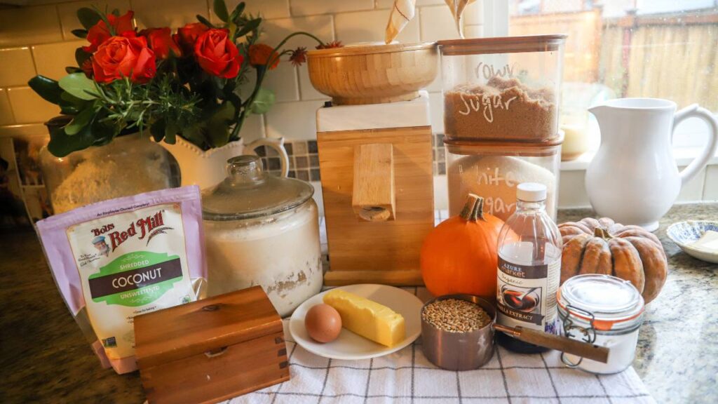 Ingredients for pumpkin coconut chocolate chip cookies arranged on a kitchen counter