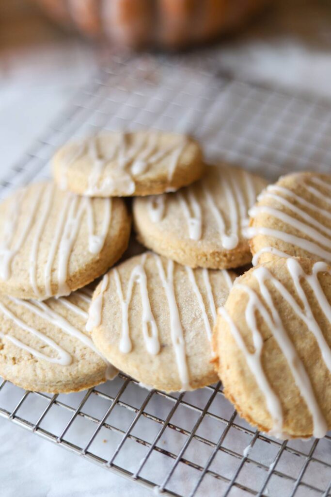 Close up of whole grain sugar cookies with white icing drizzle