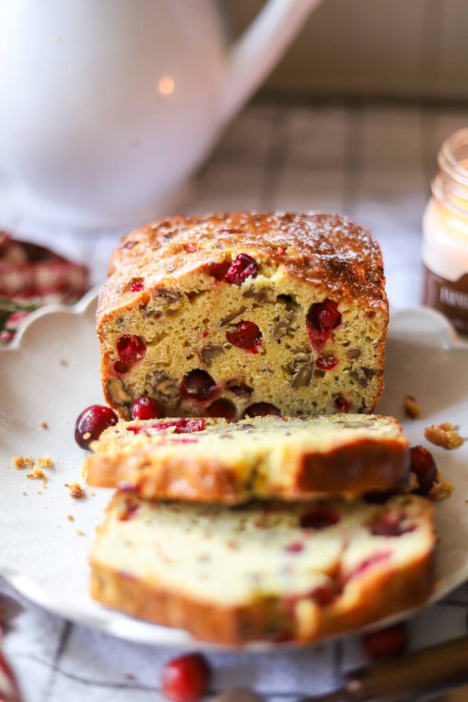 Close up of sliced cranberry orange bread with walnuts