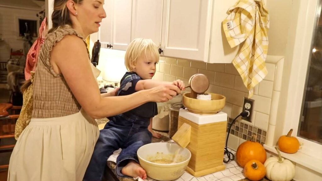 Fresh milled flour baking scene with a parent and child making pumpkin cookies together