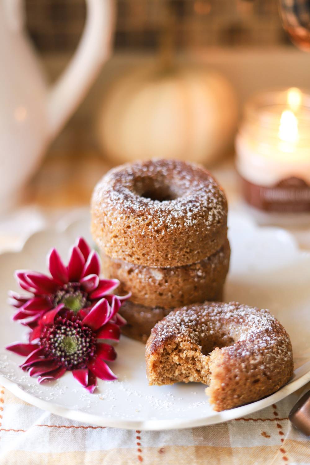 Stack of whole grain apple cider donuts with a bite taken out