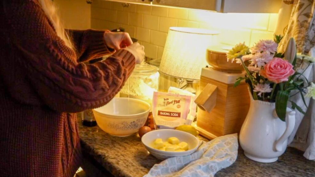 Mixing einkorn lemon sugar cookie dough with simple baking ingredients on a kitchen counter