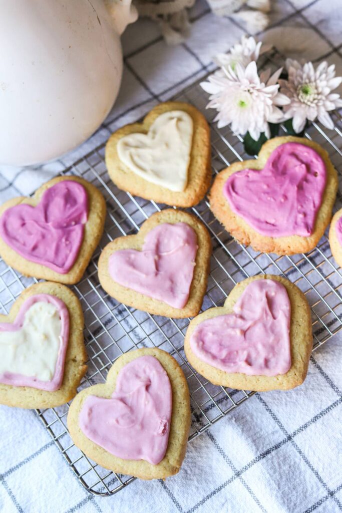 Heart-shaped einkorn lemon sugar cookies cooling on a wire rack