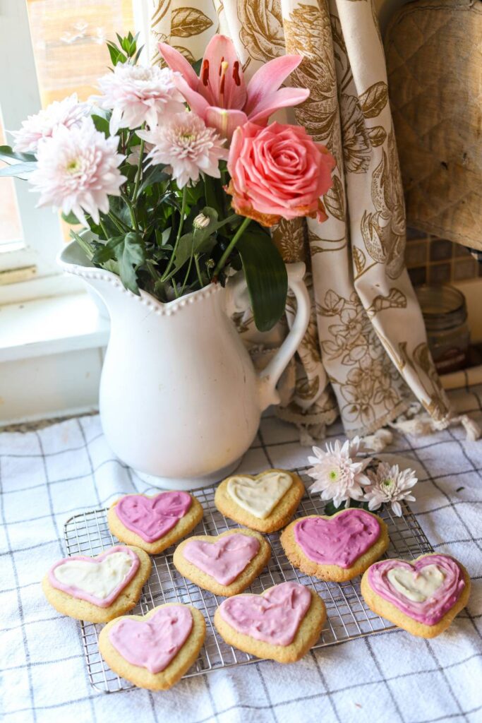 Einkorn lemon sugar cookies cooling on a wire rack near fresh flowers