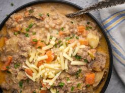 Close-up of cheeseburger soup with potatoes, carrots, and ground beef