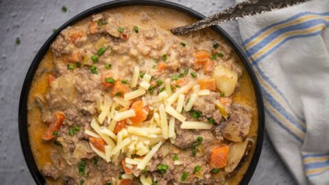 Close-up of cheeseburger soup with potatoes, carrots, and ground beef
