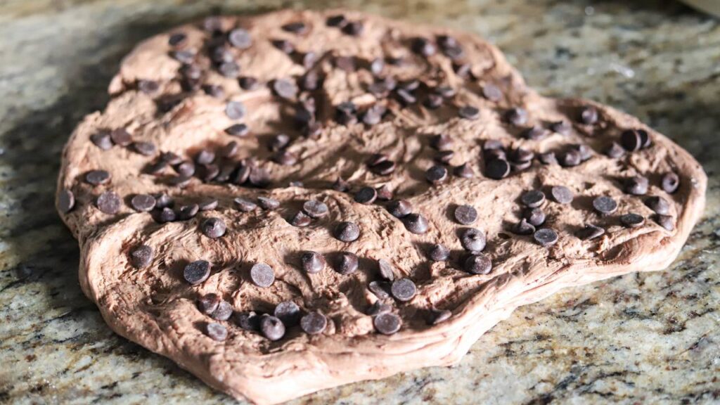 Chocolate sourdough dough spread on countertop