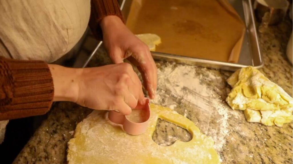 Cutting heart-shaped cookies from einkorn sugar cookie dough
