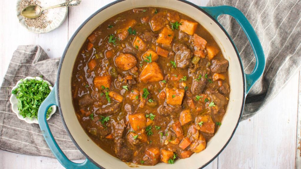Overhead view of pumpkin beef stew in a Dutch oven