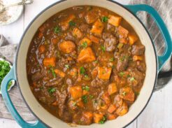 Overhead view of pumpkin beef stew in a Dutch oven