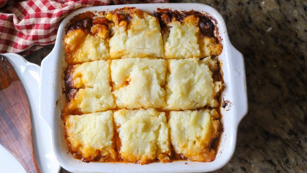 Baked shepherd’s pie in casserole dish with golden mashed potato top