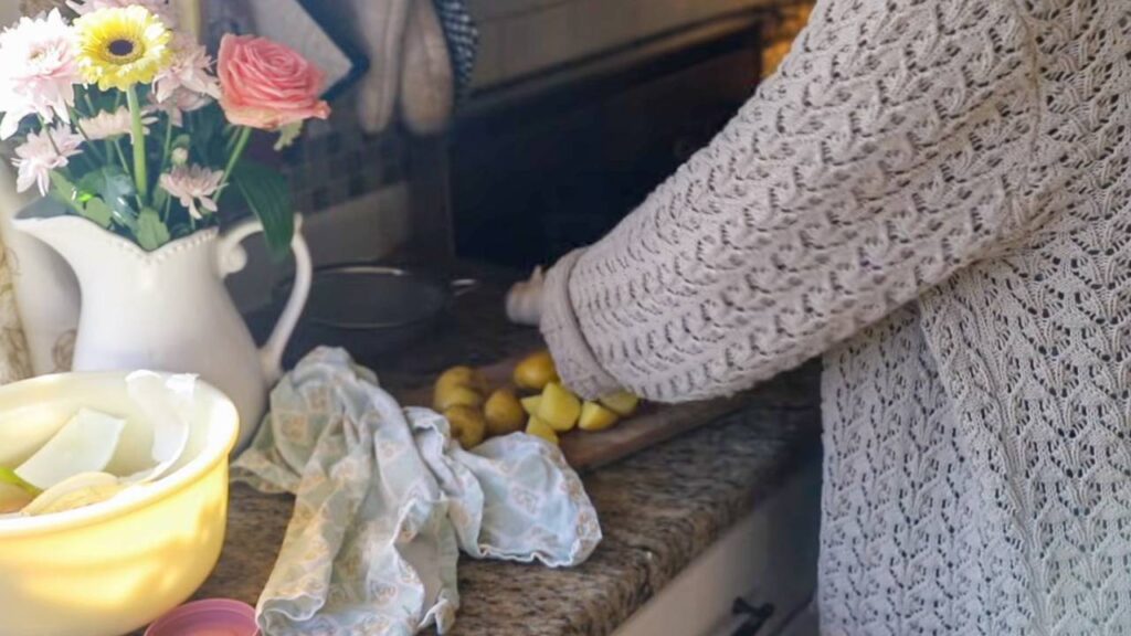 Chopping potatoes on a kitchen counter with flowers in the background