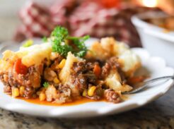 Plated shepherd’s pie with corn, carrots, and rich gravy