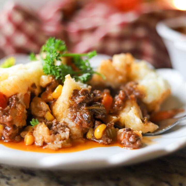 Plated shepherd’s pie with corn, carrots, and rich gravy