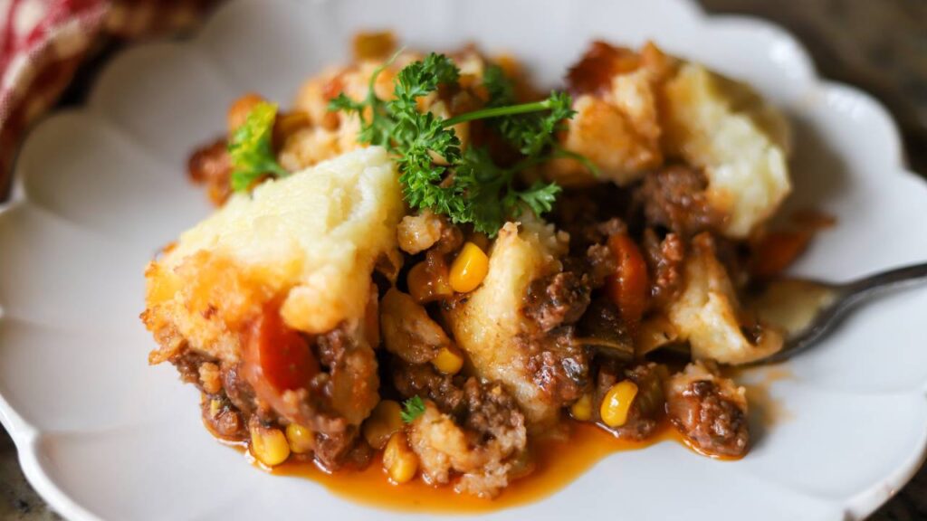 Scoop of shepherd’s pie showing creamy mashed potatoes and meat filling