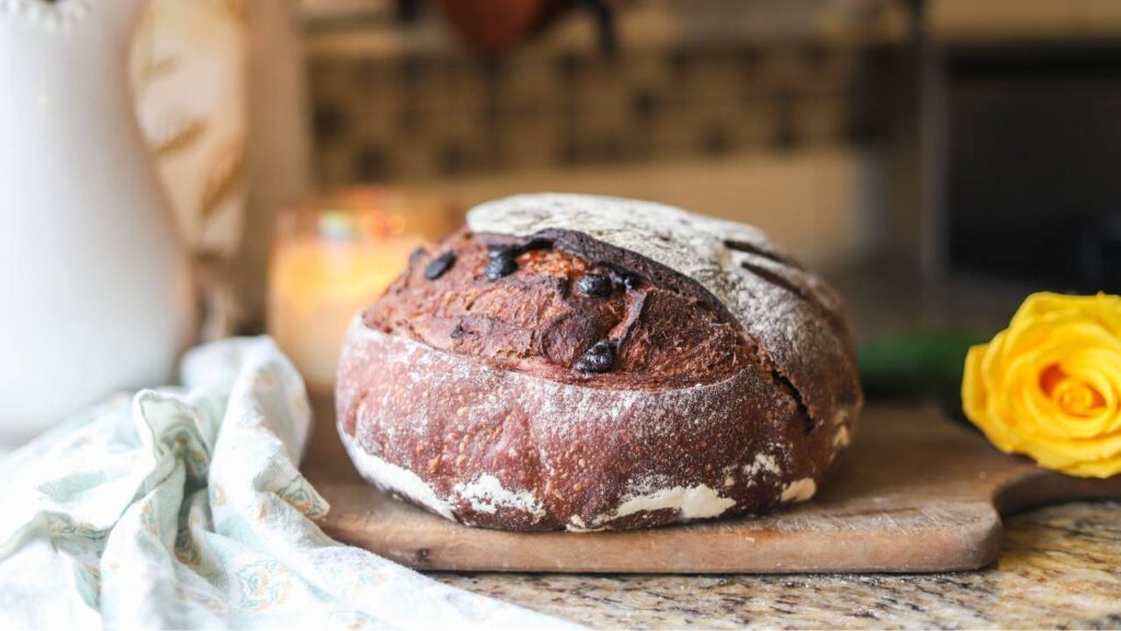 Whole sourdough chocolate bread loaf with cocoa scoring