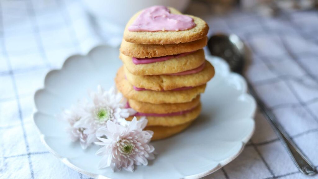 Stack of iced einkorn lemon sugar cookies on a white plate