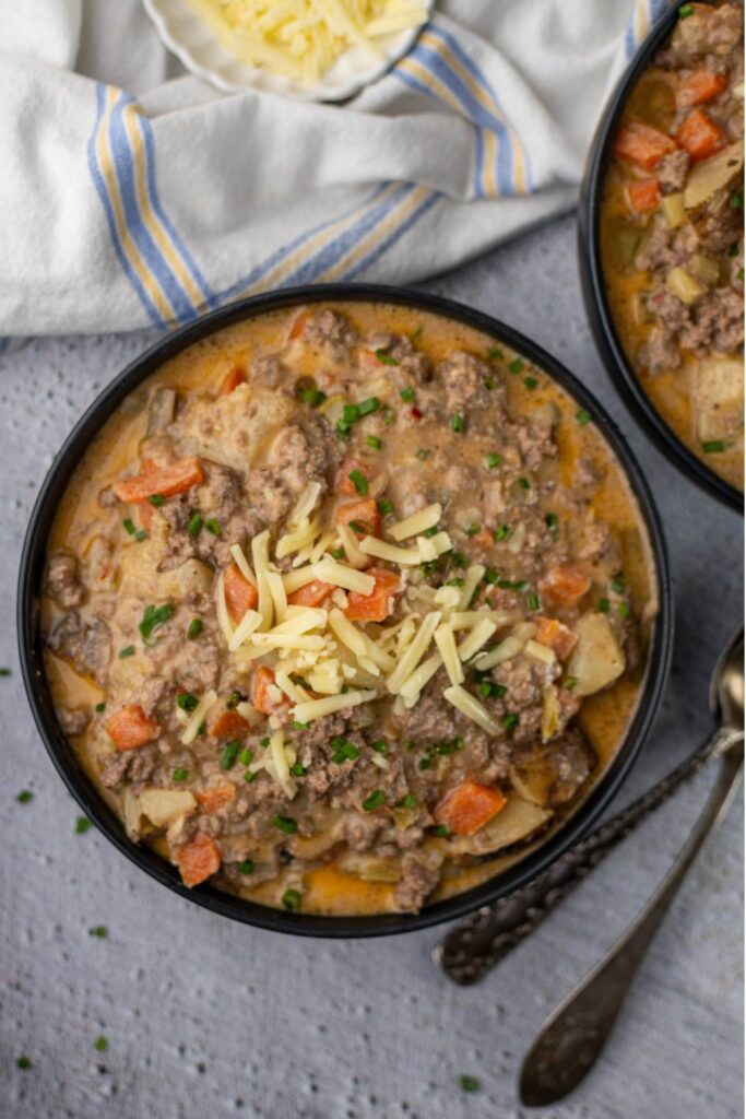 Overhead view of bowl of cheeseburger soup with cheese garnish