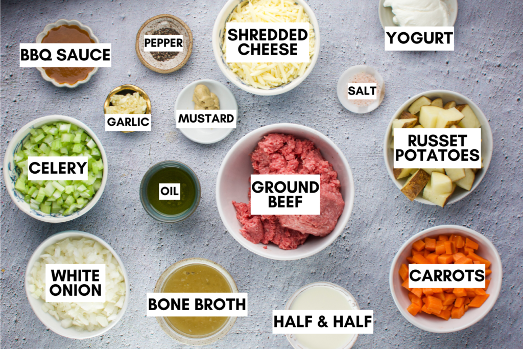 Ingredients for healthy cheeseburger soup laid out on a table